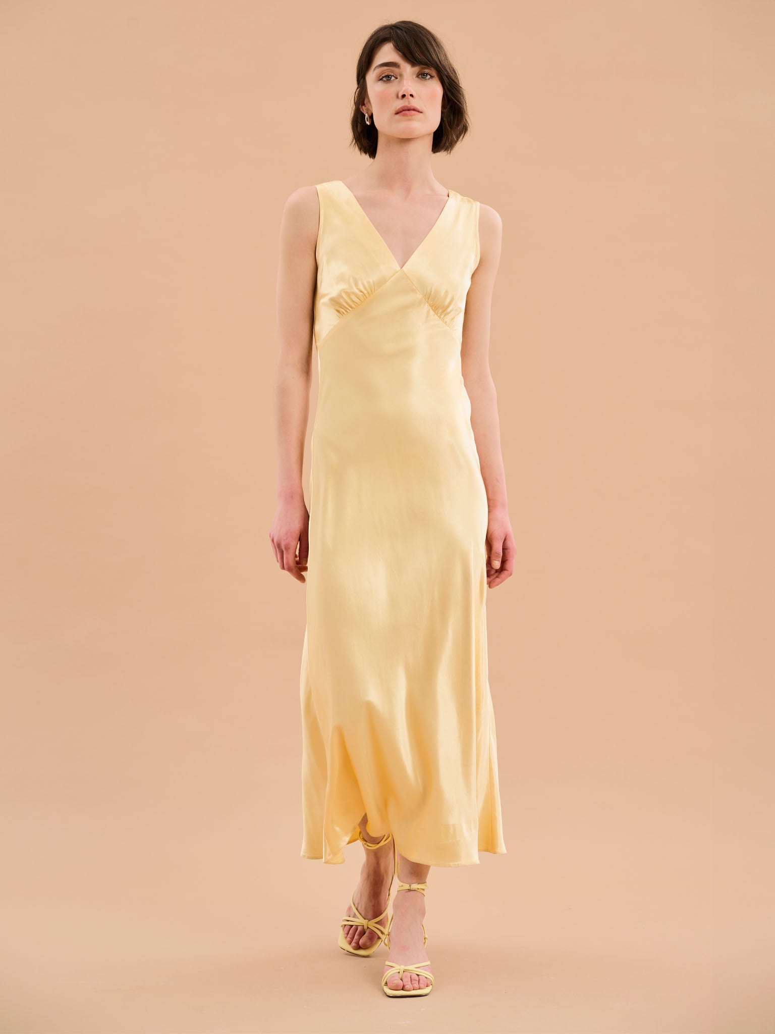 yellow satin maxi dress with v neck and ruching detail